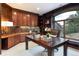 Spacious home office with wood cabinets, a large desk, and scenic views at 1189 Rembrandt Rd, Boulder, CO 80302