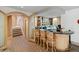 Basement wet bar with granite countertop and seating for three at 1682 Montane E Dr, Golden, CO 80401
