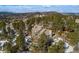 Aerial view showcasing a home's exterior, landscaping, and surrounding mountain views at 1682 Montane E Dr, Golden, CO 80401