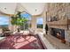Living room with stone fireplace and large windows offering mountain views at 1682 Montane E Dr, Golden, CO 80401