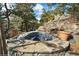 Hot tub nestled in a rocky landscape with surrounding trees at 1682 Montane E Dr, Golden, CO 80401