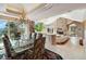 Open dining room with glass table and views from large windows at 1682 Montane E Dr, Golden, CO 80401