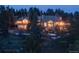 Luxury home nestled in a wooded area with mountain views at dusk at 1682 Montane E Dr, Golden, CO 80401