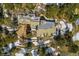 Aerial view of a luxurious home nestled in a snow-dusted landscape with mountain views at 1682 Montane E Dr, Golden, CO 80401