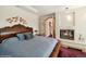 Bright bedroom with a fireplace and built-in desk area at 1682 Montane E Dr, Golden, CO 80401
