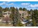 Two story home with attached garage, surrounded by trees and some snow at 1682 Montane E Dr, Golden, CO 80401