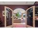 Office with double doors opening to a sunroom with mountain views at 1682 Montane E Dr, Golden, CO 80401