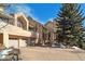 Exterior view of a two-story home with a three-car garage and stone accents at 1682 Montane E Dr, Golden, CO 80401