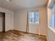 Well-lit bedroom featuring wood floors and closet at 26446 Grateful Way, Kittredge, CO 80457