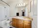 Clean bathroom with oak cabinets, a tub/shower combo, and white fixtures at 12348 W Dorado Pl # 302, Littleton, CO 80127