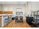 Dining area with wood table, black chairs, and adjacent kitchen at 12348 W Dorado Pl # 302, Littleton, CO 80127