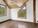 Charming bedroom with wood floors, large window, and wood ceilings at 733 Rainbow Rd, Idaho Springs, CO 80452