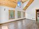 Bedroom with vaulted wood ceilings, hardwood floors, and forest views at 733 Rainbow Rd, Idaho Springs, CO 80452