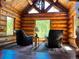 Cozy living room with log walls, hardwood floors, and stunning views at 733 Rainbow Rd, Idaho Springs, CO 80452