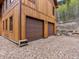 Two-car garage with brown doors and wood exterior at 733 Rainbow Rd, Idaho Springs, CO 80452