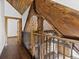 Open upper hallway with wood railing and wood flooring at 733 Rainbow Rd, Idaho Springs, CO 80452