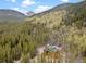 Log home with mountain views and a large lot with mature trees at 733 Rainbow Rd, Idaho Springs, CO 80452