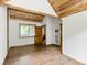 Spacious bedroom with wood floors and vaulted ceiling, featuring a large window at 733 Rainbow Rd, Idaho Springs, CO 80452