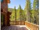 Wooden deck with scenic mountain views and dense pine forest at 733 Rainbow Rd, Idaho Springs, CO 80452
