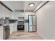 Modern kitchen with stainless steel appliances and white cabinets at 555 E 10Th Ave # 3, Denver, CO 80203