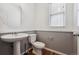 Clean powder room with pedestal sink and gray-toned walls at 5694 Pinto Valley St, Parker, CO 80134