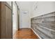 Inviting entryway with barn door, wood-paneled accent wall, and hardwood floors at 5694 Pinto Valley St, Parker, CO 80134