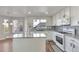 Modern kitchen with white cabinets, granite countertops, and a large island at 10217 Lauren Ct, Highlands Ranch, CO 80130