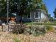 Side view of a ranch home with light blue siding and xeriscaping at 6631 78Th Ave, Commerce City, CO 80022