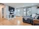 Living room featuring hardwood floors, sectional sofa and electric fireplace at 9211 Garrison St, Broomfield, CO 80021