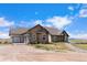 House exterior showcasing stone, stucco, and a three-car garage at 7384 E Greenland Rd, Franktown, CO 80116