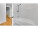 Bathroom with tub shower combo and hardwood floors at 1431 Tamarac St, Denver, CO 80220