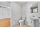 Small bathroom with pedestal sink and toilet at 1431 Tamarac St, Denver, CO 80220