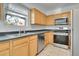 Modern kitchen with stainless steel appliances and wood cabinets at 1431 Tamarac St, Denver, CO 80220