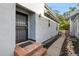Side entrance with stone steps leading to a black security door at 1431 Tamarac St, Denver, CO 80220