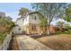 Two-story home with brick and stucco exterior, paved driveway at 1431 Tamarac St, Denver, CO 80220