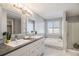 Elegant bathroom with double vanity and patterned tile at 4181 S Shawnee St, Aurora, CO 80018