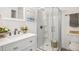 Updated bathroom with walk-in shower and white vanity at 4181 S Shawnee St, Aurora, CO 80018