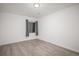 Simple and bright bedroom with gray curtains and wood-look floors at 4181 S Shawnee St, Aurora, CO 80018