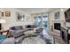 Living room with L-shaped sofa, fireplace, and sliding glass doors to backyard at 8901 S Ukraine Ct, Aurora, CO 80016