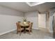 Basement dining area with round wooden table and four chairs, perfect for small gatherings at 8901 S Ukraine Ct, Aurora, CO 80016