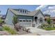 Two-story craftsman style home with gray siding, stone accents, and a two-car garage at 8901 S Ukraine Ct, Aurora, CO 80016