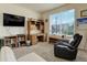 Bright home office featuring a large desk, comfortable chair, and built-in shelving at 8901 S Ukraine Ct, Aurora, CO 80016