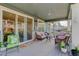 Relaxing covered back patio with wicker furniture and sliding glass doors leading to the interior at 8901 S Ukraine Ct, Aurora, CO 80016