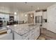 Modern kitchen with white cabinets, granite island, and stainless steel appliances at 8901 S Ukraine Ct, Aurora, CO 80016