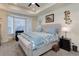 Spacious main bedroom with bay window, ceiling fan, and dresser at 8901 S Ukraine Ct, Aurora, CO 80016