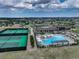 Aerial view of community pool, tennis courts, and clubhouse at 8901 S Ukraine Ct, Aurora, CO 80016