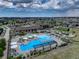 Aerial view of community pool with surrounding lounge chairs and clubhouse at 8901 S Ukraine Ct, Aurora, CO 80016