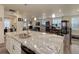 Modern kitchen with a large granite island and stainless steel appliances at 8901 S Ukraine Ct, Aurora, CO 80016