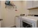 Convenient laundry room with washer, dryer, and storage shelving at 8901 S Ukraine Ct, Aurora, CO 80016