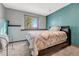 Cozy bedroom with a double bed and teal colored walls at 2460 Eileen Way, Parker, CO 80138